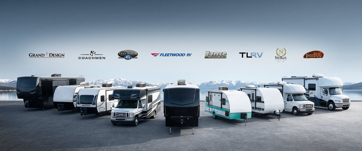 Fogatti RV accessories compatible with major camper brands including Grand Design, Coachmen, and Fleetwood, displayed with various travel trailers and fifth wheels by a scenic mountain lake.