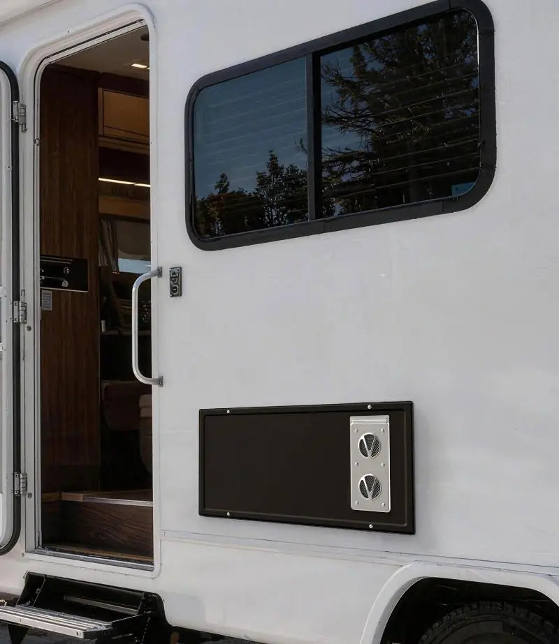 A white RV with an open door and a window, equipped with fogatti rv furnace