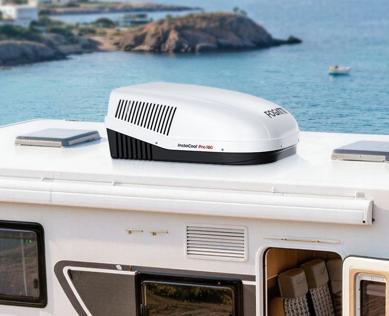 Rooftop RV air conditioner installed on a travel trailer during a sunny summer trip